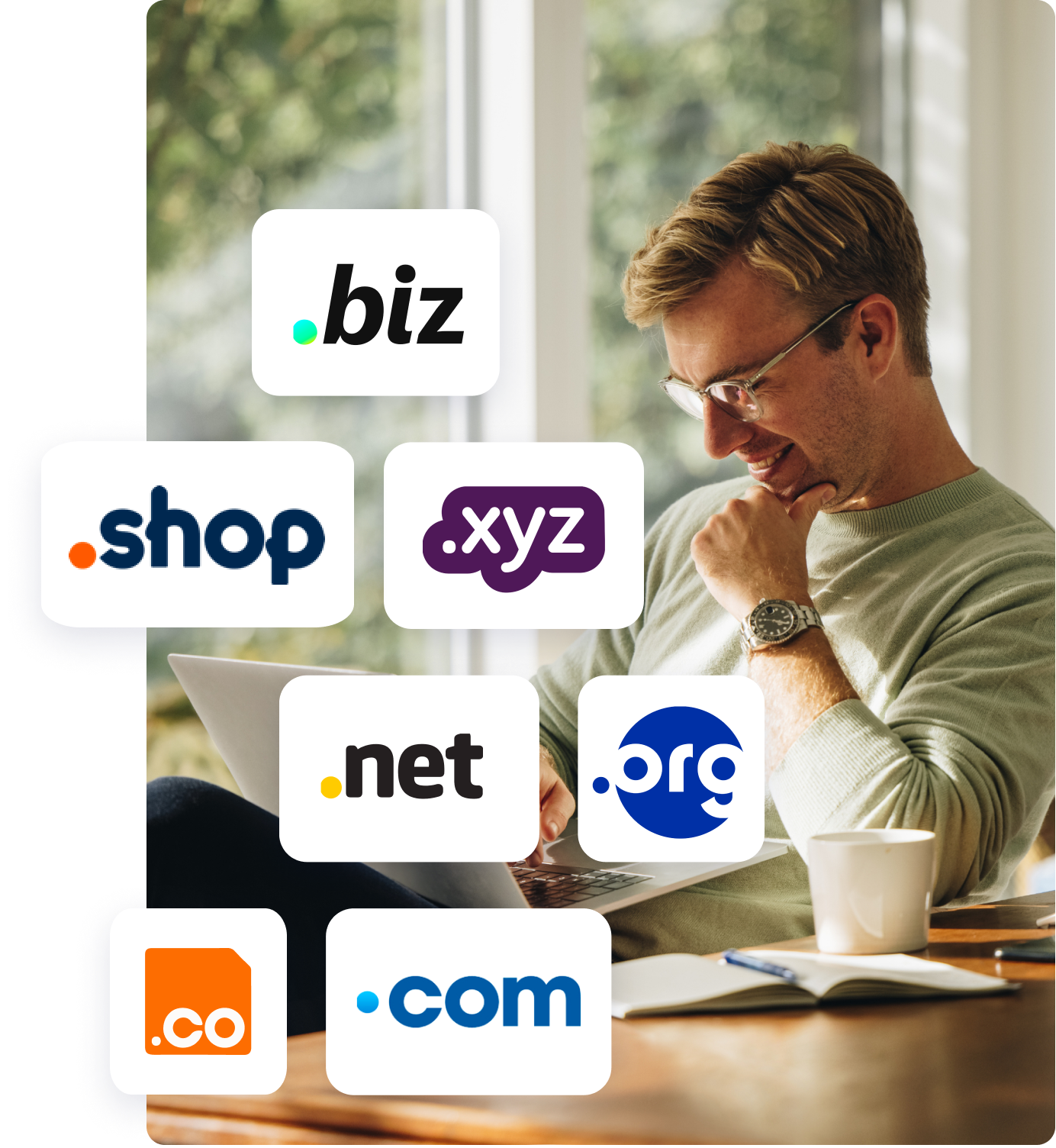 middle aged man with glasses at desk on laptop smiling with top-level domain logos floating over image